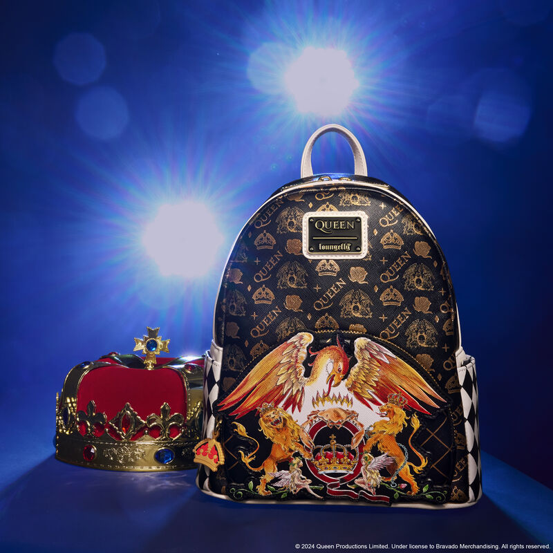 Black and white mini backpack inspired by the band Queen, featuring an all-over print of the band's logo, crowns, and roses in gold foil. The front pocket features their logo with a royal crown, a phoenix, crab, lions, and fairies. The bag sits beside a royal crown against a blue background, backlit by two spotlights